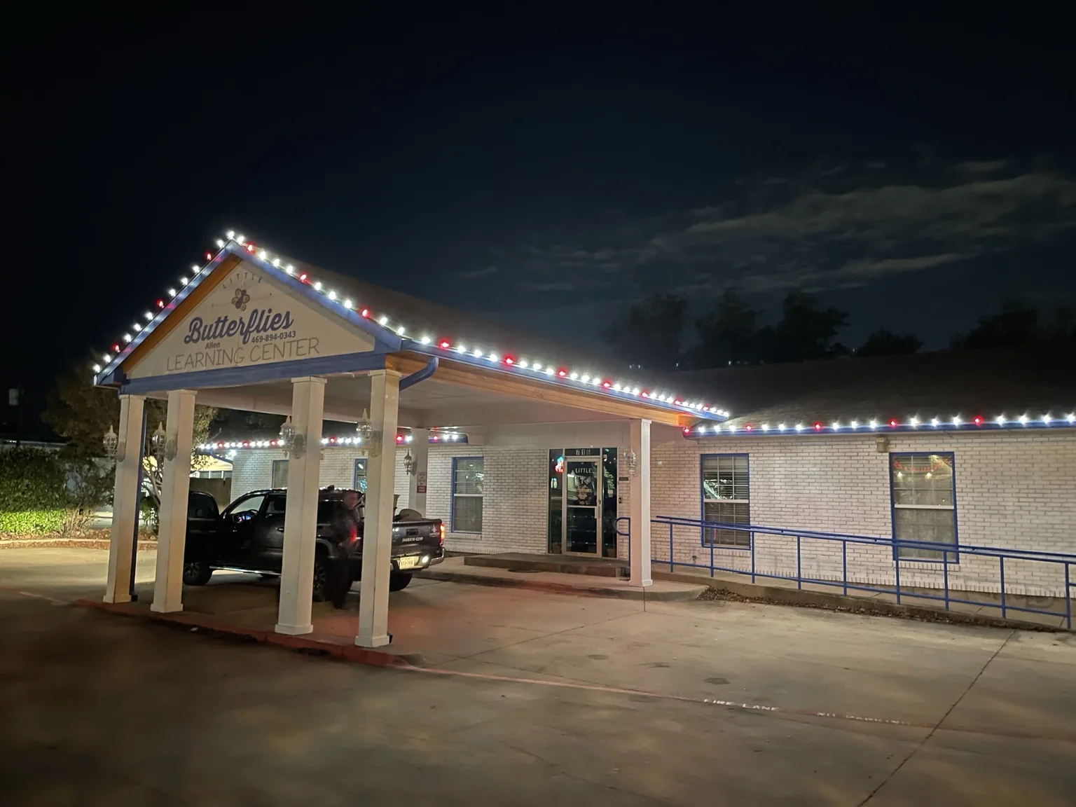NorthStar red and white Christmas light installation outlining a commercial learning center roofline
